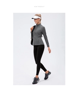 Close-up of grey zip-up fitness jacket and black leggings with side pocket details