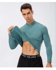 Close-up of teal men's quarter-zip fitness pullover with breathable quick-dry fabric