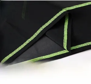 Detail of high-waist mesh hem with neon green stitching on breathable sports top