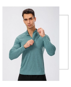 Detail of the stand collar and quarter-zip closure on this men's teal running sweatshirt