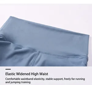 Detailed close-up of high-waisted blue yoga shorts with wide elastic tummy control band
