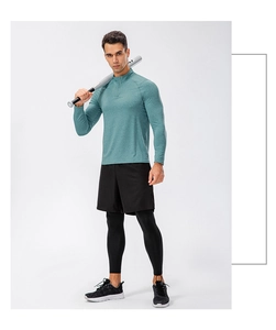 Three-piece men's athletic set with teal quarter-zip top and black leggings for training