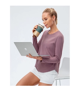 Close-up of women's loose fitness top with curved hem and drop shoulder in mauve color
