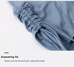 Macro detail of adjustable drawstring side ties on light blue yoga shorts with pleated texture