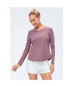 Close-up of women's yoga long sleeve shirt featuring a round neck and curved hem in dusty pink