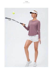 Action shot of women's mauve long sleeve yoga t-shirt for tennis and fitness training