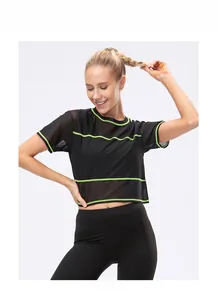 Close-up of black breathable mesh fabric with vibrant neon green stripes on gym top