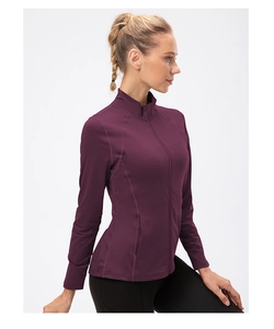 Side view of slim-fit women's workout jacket in deep purple with stand collar and zipper