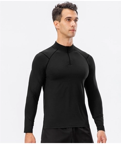 Close-up of black half-zip collar and raglan sleeve seams on men's dry-fit sports top