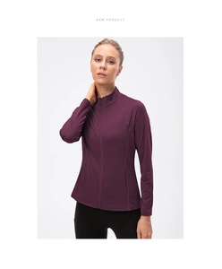 Detail view of deep purple full-zip yoga jacket with stand collar and raglan sleeves