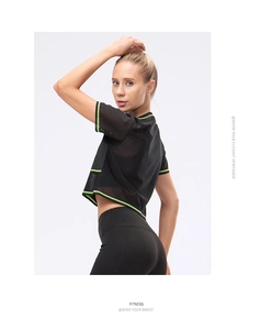 Detail of mesh sports t-shirt with neon green trim for breathable fitness training