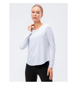 Detail view of white long-sleeved yoga top with curved hem and quick-dry breathable fabric