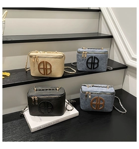 Detail view of retro box bags in four colors with chain straps and circular logo design