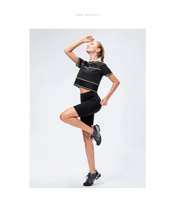 Women's black athletic shorts and short sleeve top set with green stripe details
