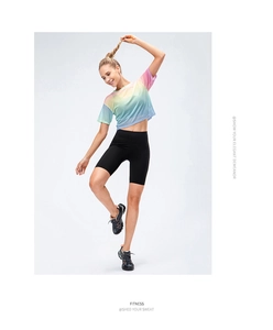 Studio shot of women's rainbow gradient crop top and black high waist cycling shorts