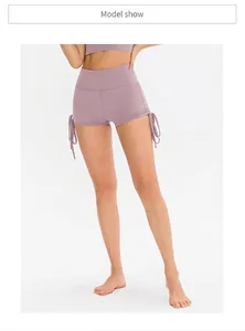 Detail view of high waist lavender yoga shorts with adjustable side drawstrings and ruching