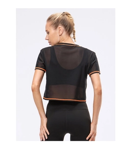 Detail of breathable black mesh cropped top with orange trim for fitness sports