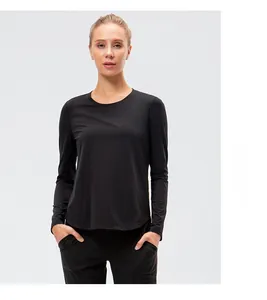 Detailed view of women's black long sleeve workout shirt with curved hem and crew neck