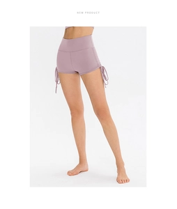 Detailed view of side drawstrings and high waistband on light purple yoga shorts