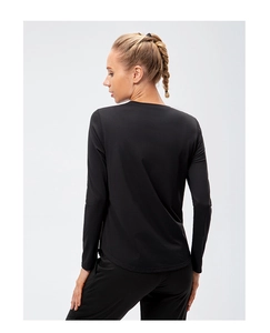 Rear view of black long-sleeved yoga shirt showing slim fit cut and curved hemline
