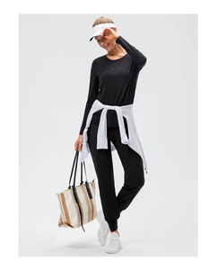 Close-up of black long sleeve yoga t-shirt and jogger set with moisture-wicking fabric