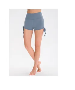 Detail of high-waist fitness shorts in mist blue with adjustable side drawstring ruching