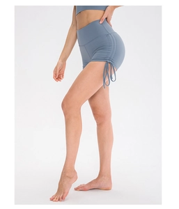 Detail of high waisted yoga shorts with side drawstring ruching and butt lifting effect