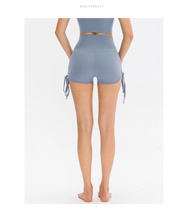 Detail view of high-waisted yoga shorts in misty blue with adjustable side drawstrings