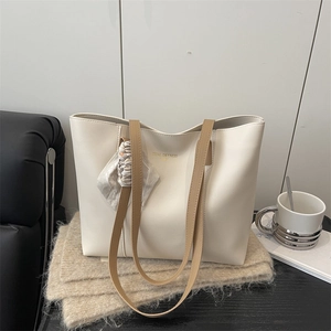 Chic off-white PU leather tote bag with khaki straps and decorative silk scarf detail