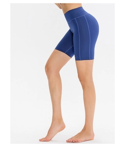Detail of high waisted dark blue yoga shorts with side stitching and matte elastic fabric