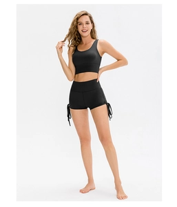 Close-up of high-waist yoga shorts featuring adjustable side drawstrings and elastic fabric