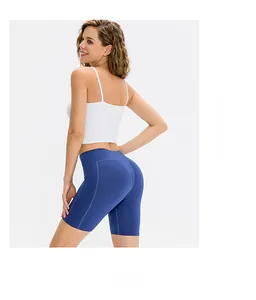 Rear view of high-waisted royal blue yoga shorts with push-up effect and white tank top