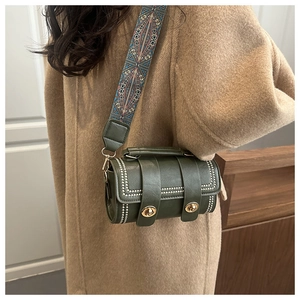 Detail of vintage green Boston bag with silver studs and ethnic geometric strap
