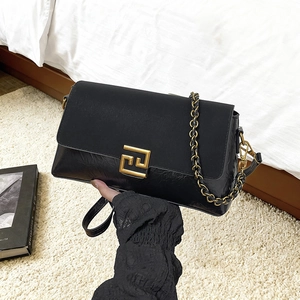 Fashionable black faux leather shoulder bag with gold chain strap and geometric metal buckle