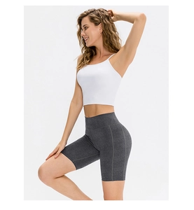 Detail of high-waist grey yoga shorts with side pocket for women running and fitness