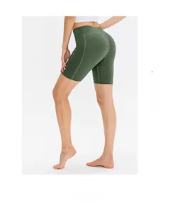 Detail view of high-waist green yoga shorts with ergonomic seams and elastic fabric