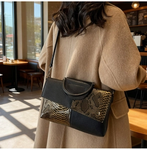 Detail of snake skin patchwork handbag on a model in a cozy cafe setting