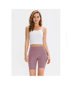 Detail shot of purple high-waisted yoga shorts and a white sports bra for women
