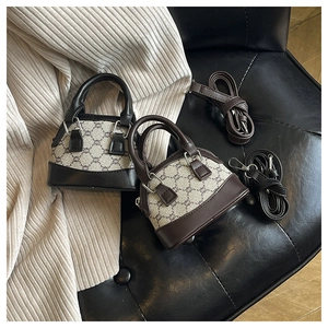 Detailed top view of vintage shell bags in black and brown monogram textured leather