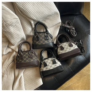 Macro view of four mini shell handbags with vintage patterns and adjustable straps