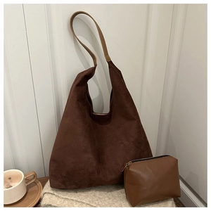 Detail view of retro brown suede tote set with large shoulder bag and small zipper pouch
