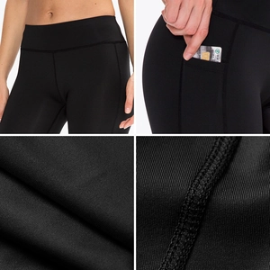 Detail view of high-waist black yoga shorts showing side pocket and flatlock stitching