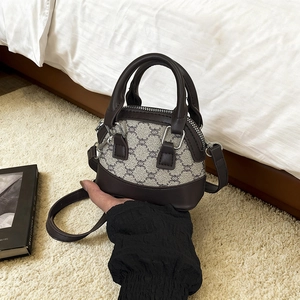 Retro patchwork shell handbag with geometric pattern fabric and brown leather strap