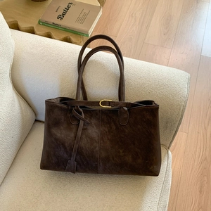 Large capacity dark brown suede tote bag displayed on a cozy textured sofa