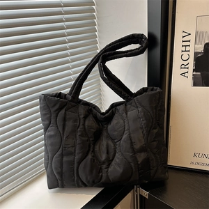Chic black quilted nylon tote bag with wave stitching and large capacity for daily use