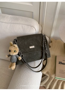 Detail of vintage olive green tie-dye chain bag with silver buckle and cute bunny charm