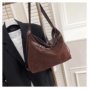 Detail of dark brown suede Hobo bag with side belt straps and premium metallic hardware