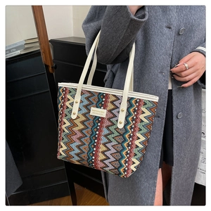 Detail of colorful chevron weave pattern and white leather trim on large tote bag
