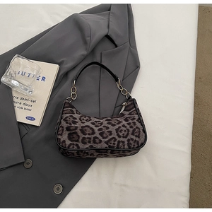 Close-up of leopard print hobo bag featuring plush texture and gold chain detail
