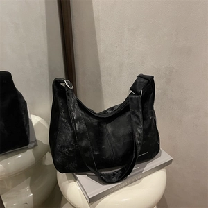 Large capacity vintage black hobo bag with distressed texture on white stools